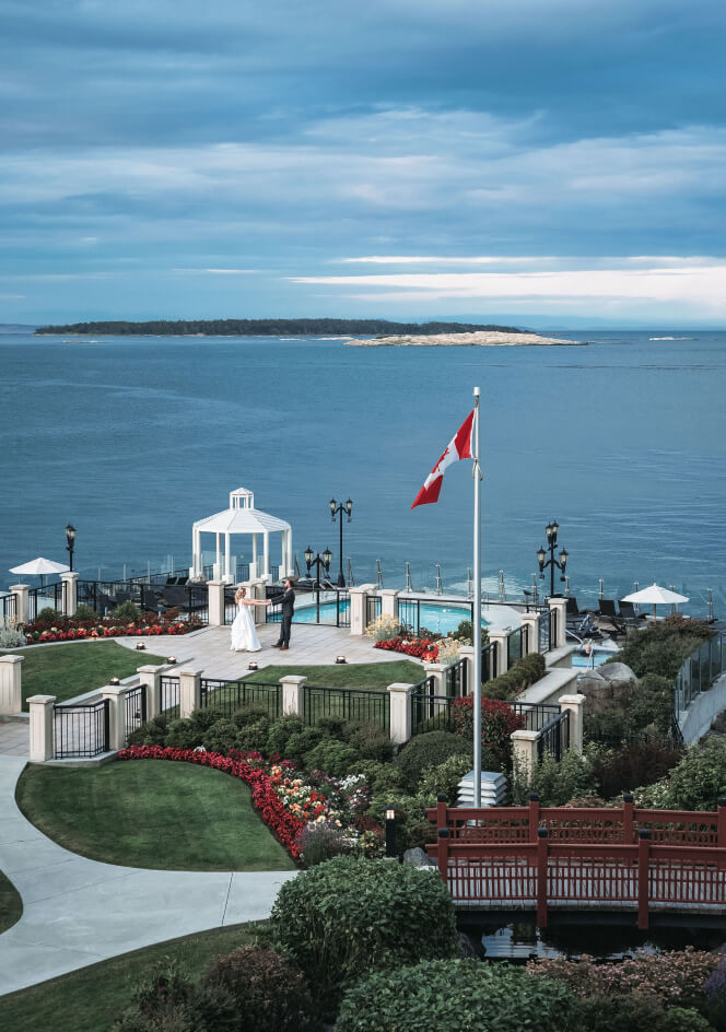 veranda view of wedding couple dancing with oceanfront views overlooking mineral pools