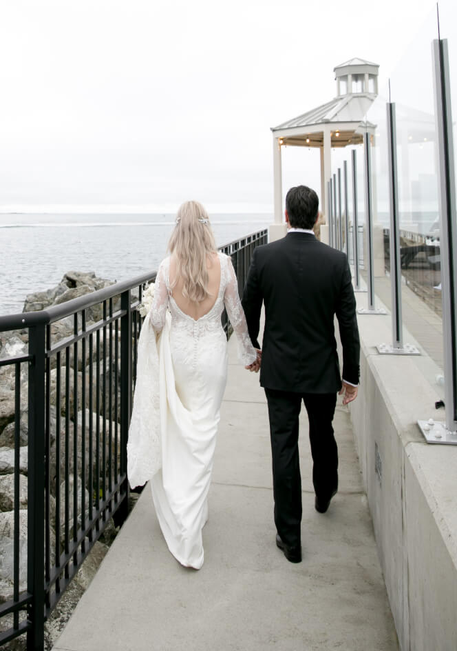 bride and groom walking to gazebo ocean views