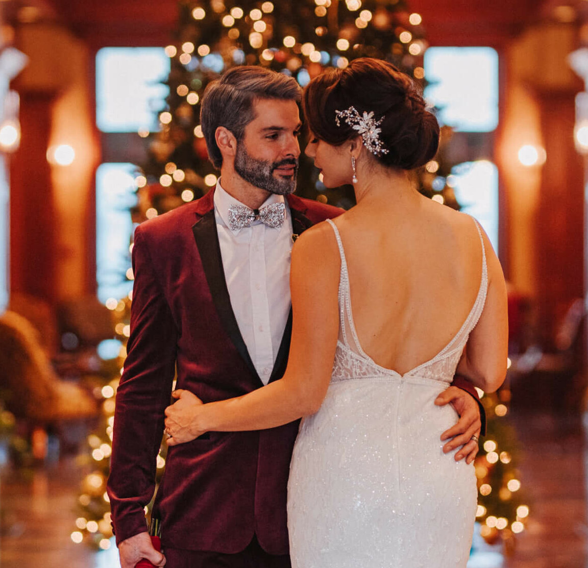 wedding couple winter holidays christmas white dress velvet crush red blazer poinsettia roses