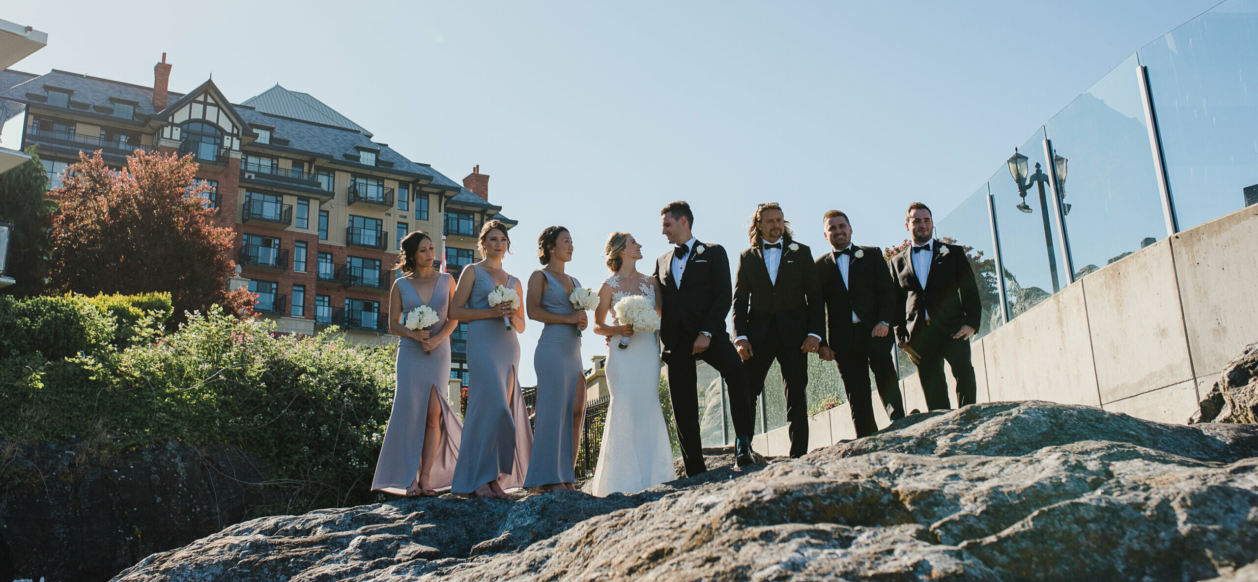 Wedding party with oak bay beach hotel behind them