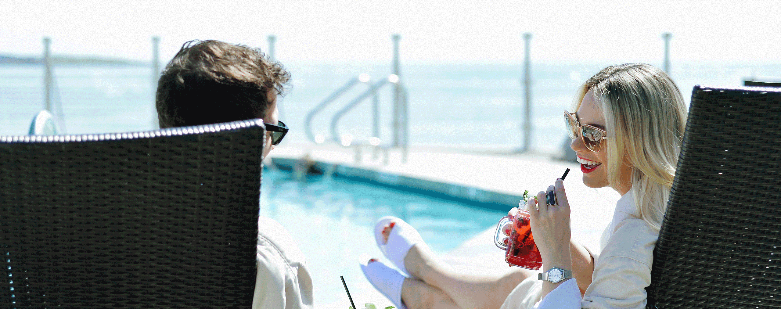 young couple enjoying pool side cocktails boathouse kitchen and bar