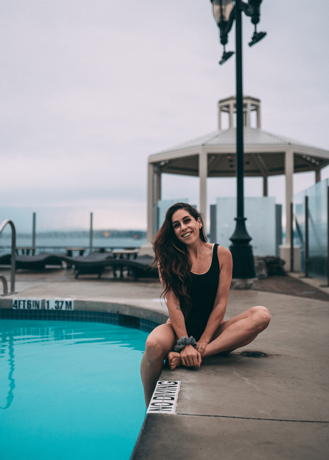 oak bay beach hotel mineral pool attractive woman smiling sitting poolside