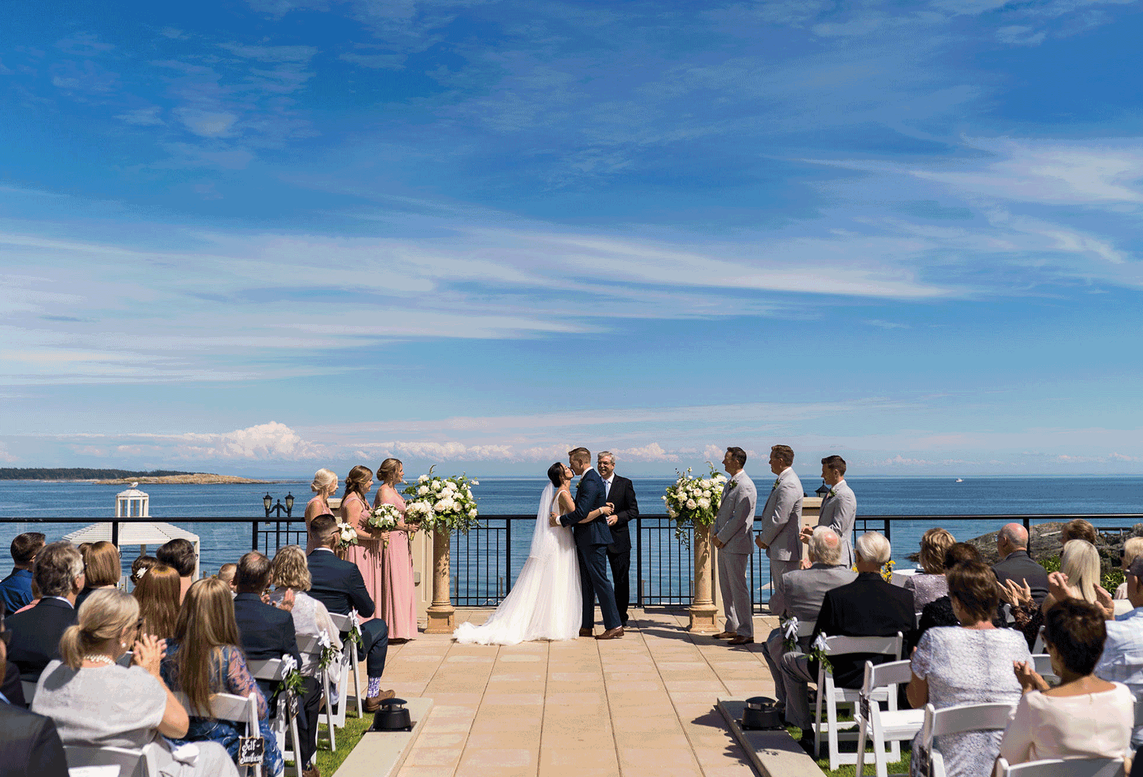 oak bay beach hotel seaside garden wedding ceremony bride and groom kissing