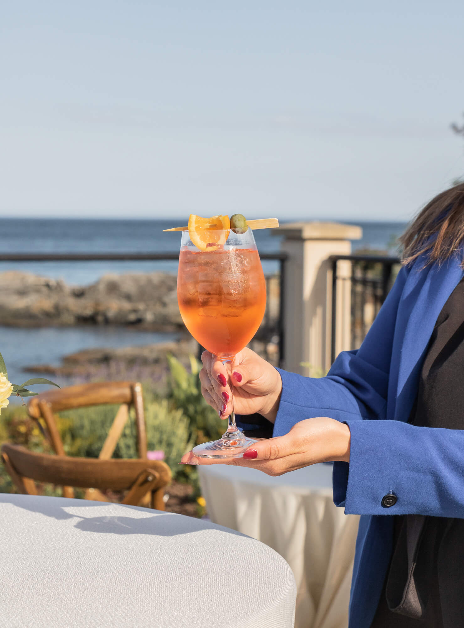 fresh cold aperol spritz with ocean behind