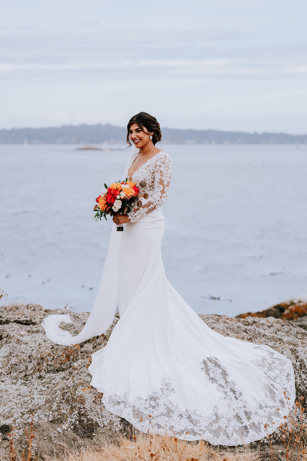 bride by ocean, colourful wedding flowers